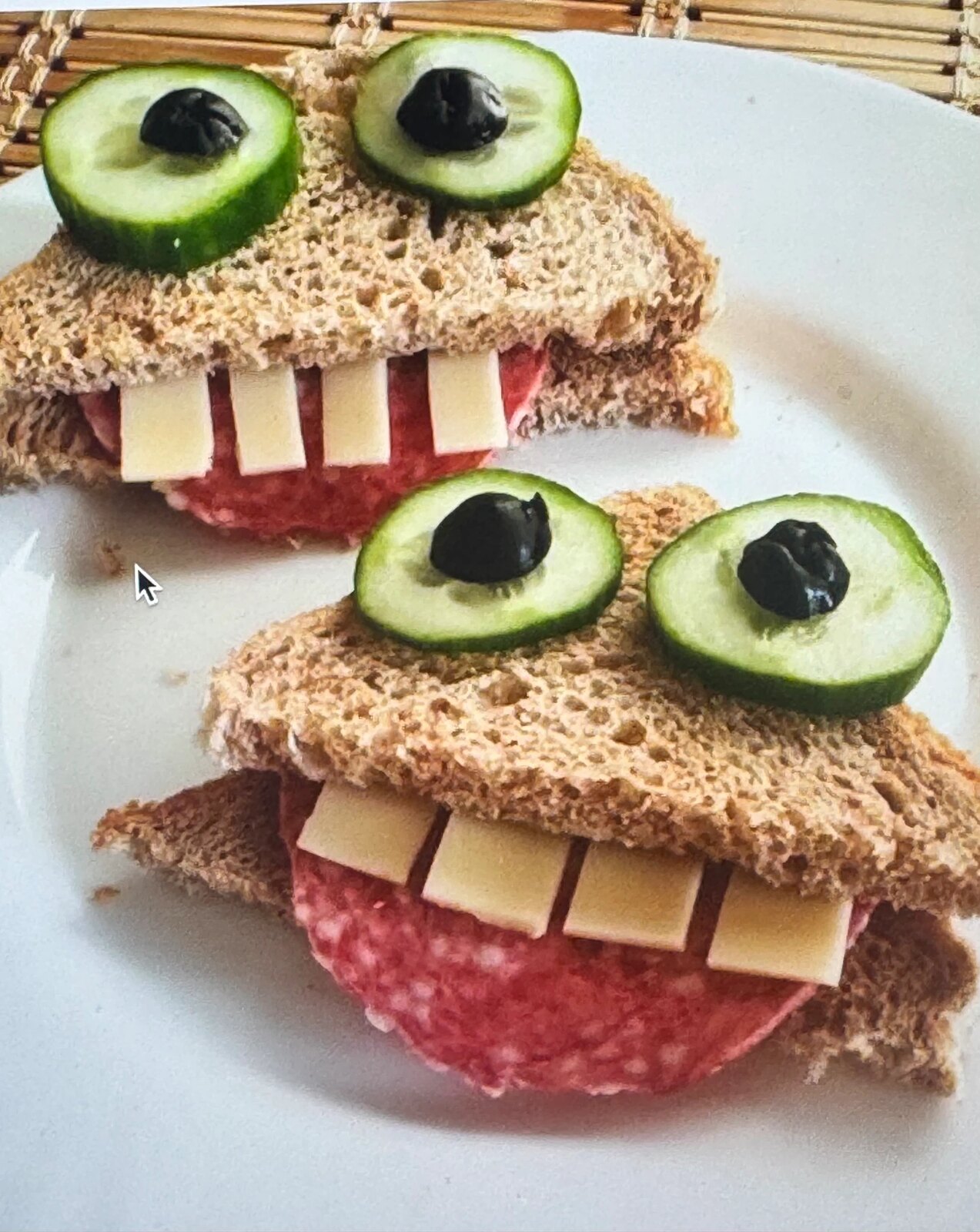 Sandwiches styled as friendly monsters with cucumber eyes
