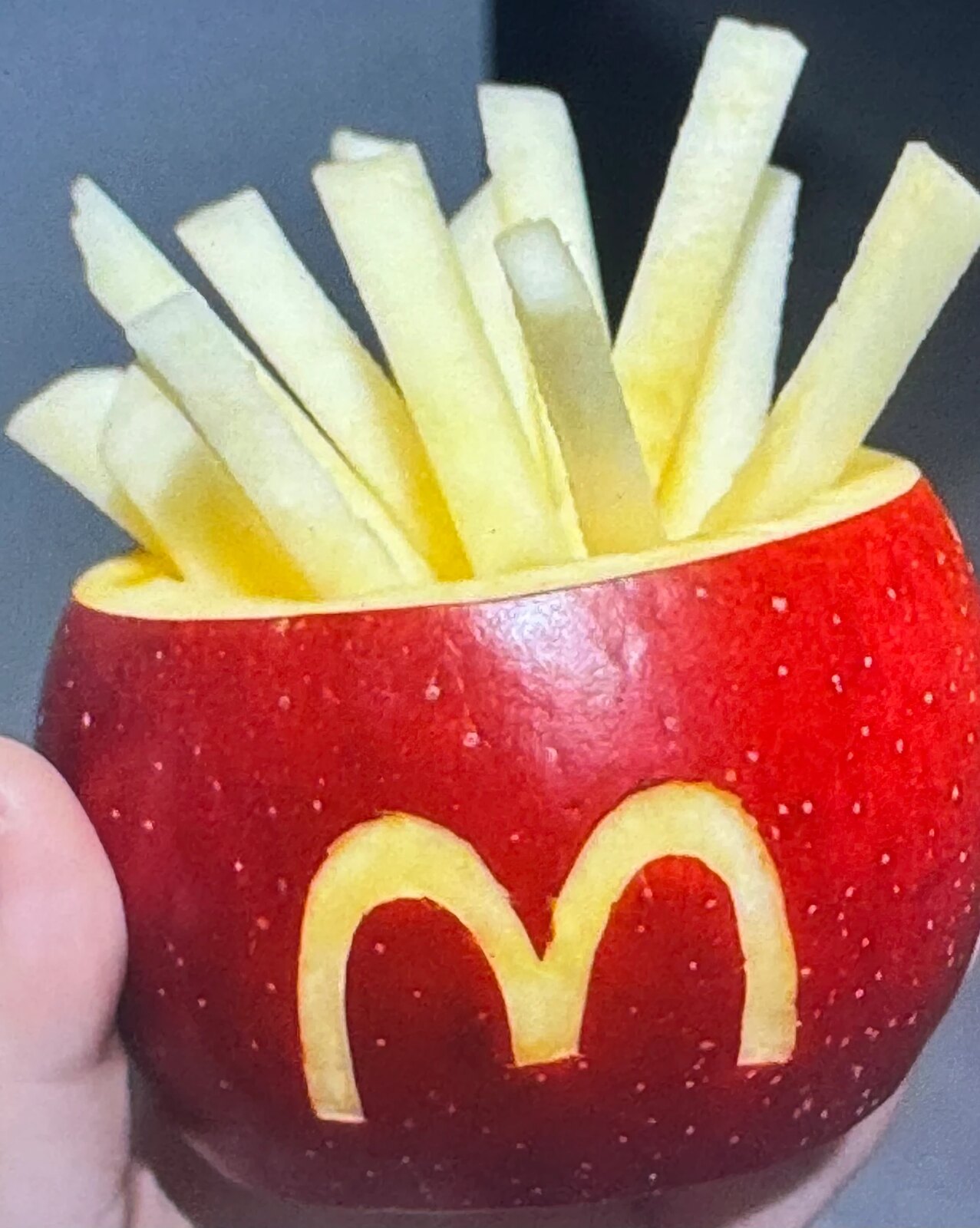 Apple carved into a fries carton with apple batons